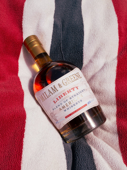 Bottle of William & Green Liberty Blend of Strained American Whiskeys on a striped towel background
