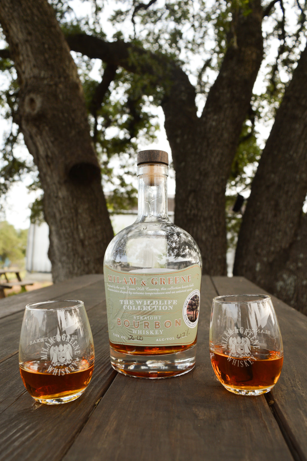 Milam and Greene Wildlife Collection Live Oak Straight Bourbon with two tasting glasses