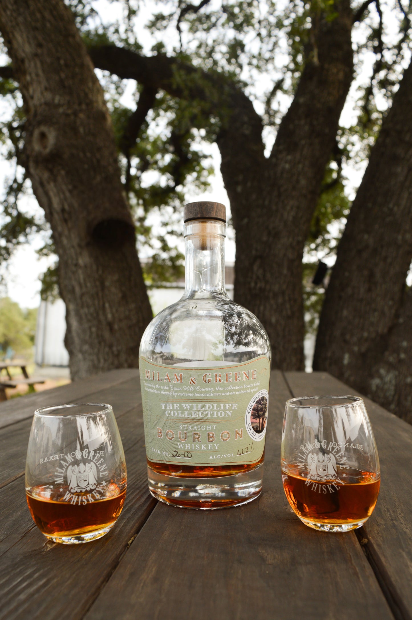 Milam and Greene Wildlife Collection Live Oak Straight Bourbon with two tasting glasses