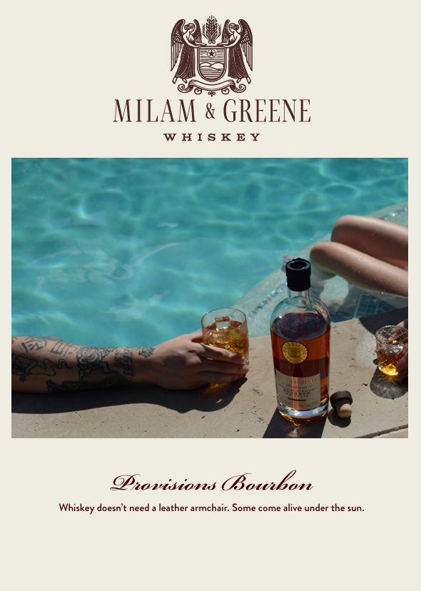 Two humans enjoy a bottle of Provisions Bourbon by the pool.