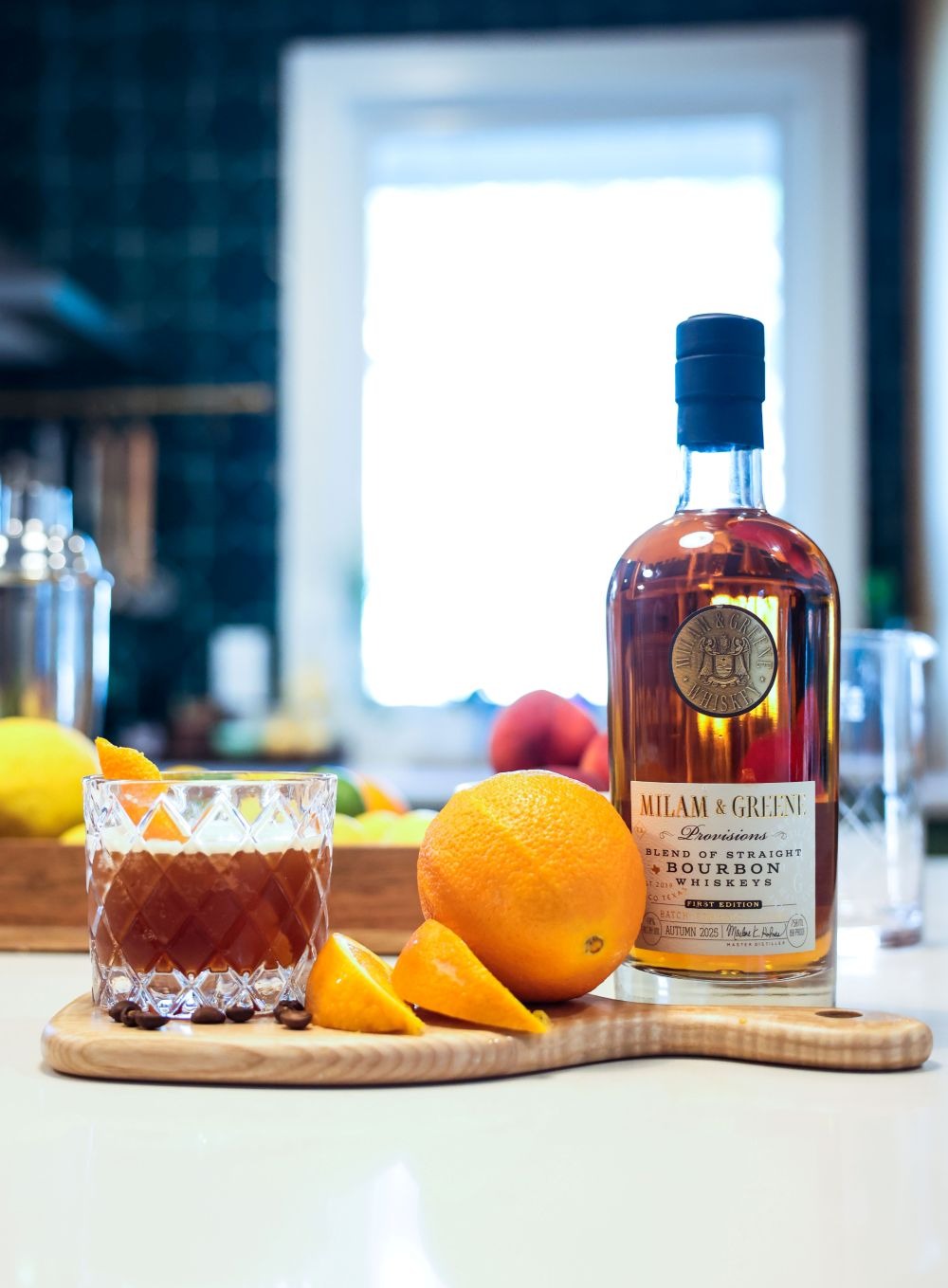 Texajillo_Provisions_Website_small_cropped delicious bourbon next to a freshly cut orange and a Texajillo cocktail atop a counter in a brightly lit kitchen